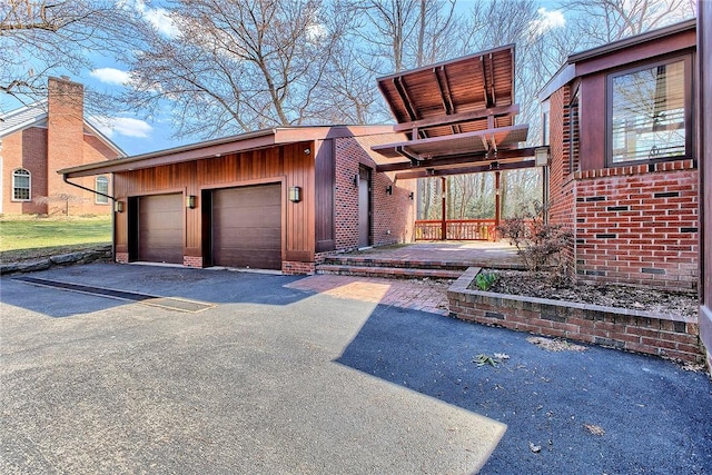 view of front of property with a garage and brick siding