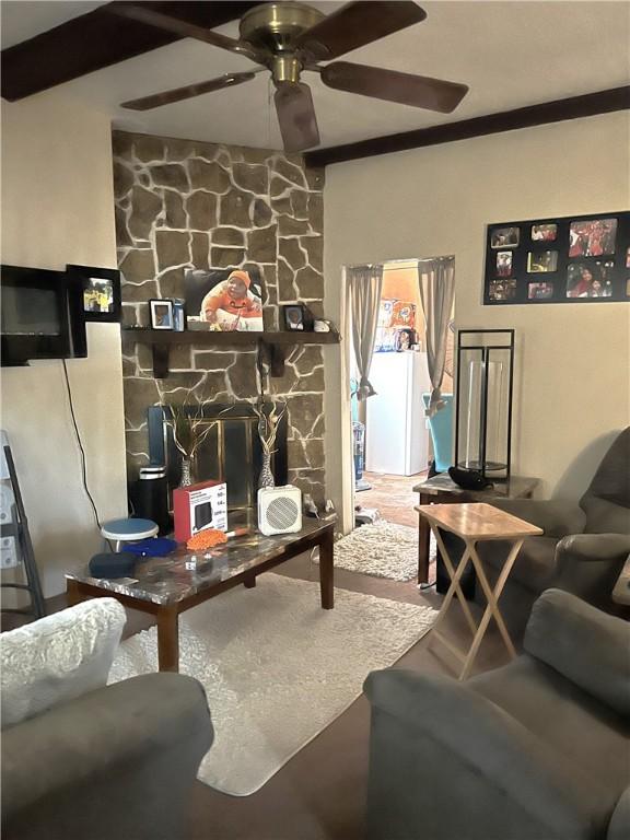 living room featuring beam ceiling and ceiling fan