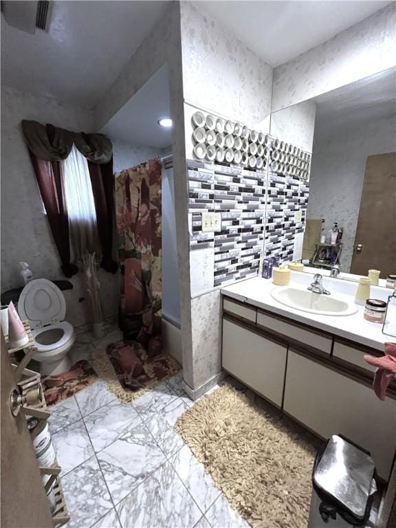 full bath featuring marble finish floor, toilet, vanity, and a shower with curtain