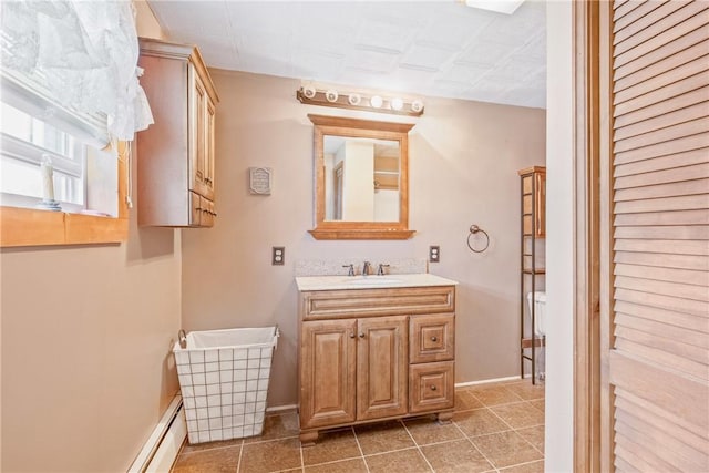 bathroom featuring vanity, baseboards, and tile patterned flooring