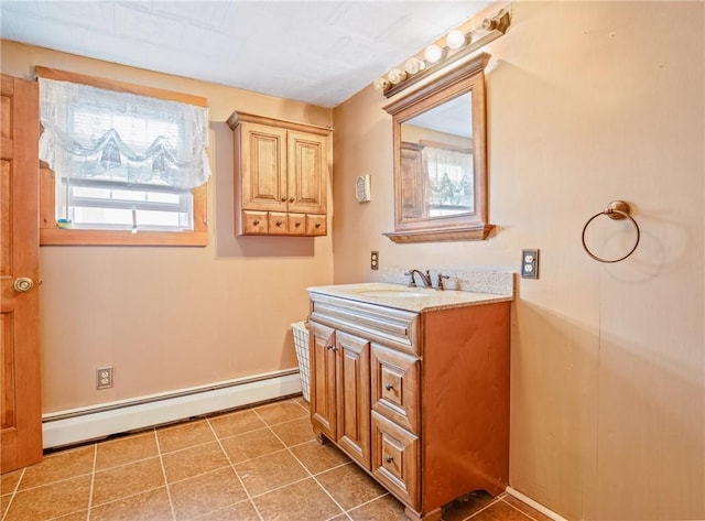 bathroom with tile patterned floors, a baseboard radiator, and vanity