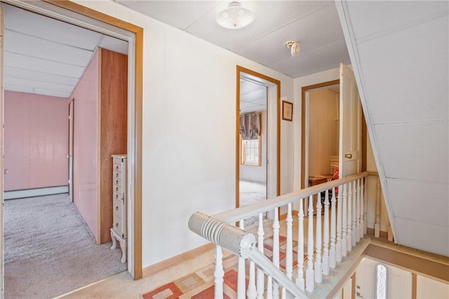 hallway featuring a baseboard heating unit and carpet flooring