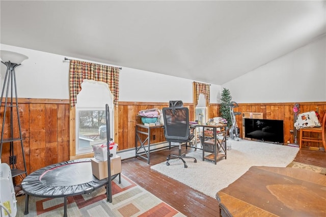 office space featuring a wainscoted wall, a baseboard heating unit, hardwood / wood-style floors, wooden walls, and lofted ceiling