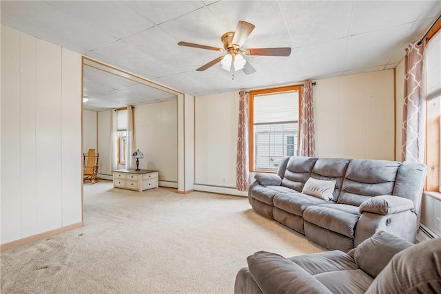 living room featuring carpet flooring, baseboard heating, and a ceiling fan