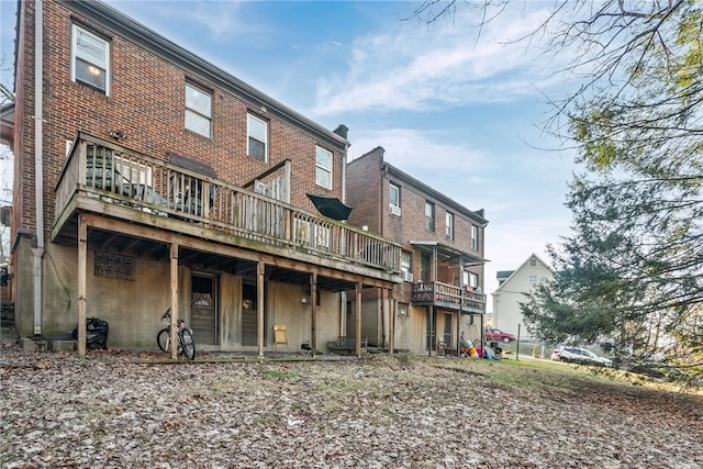 back of property featuring brick siding