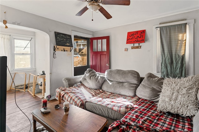 living area with wood finished floors and a ceiling fan