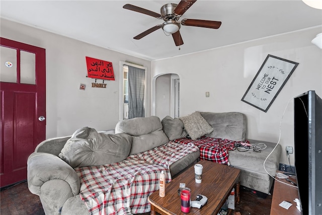 living room with arched walkways and ceiling fan