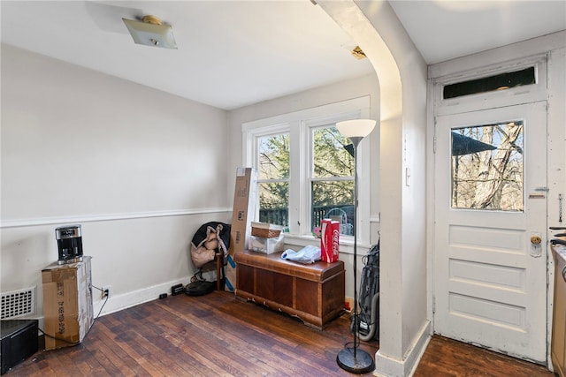 entryway featuring plenty of natural light, arched walkways, visible vents, and wood-type flooring