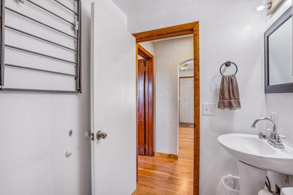 bathroom with a sink and wood finished floors