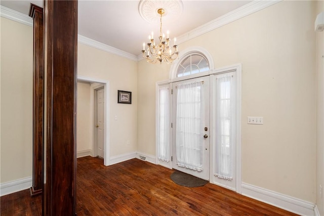 foyer with baseboards, a chandelier, dark wood finished floors, and crown molding