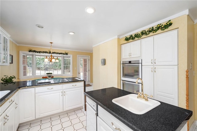 kitchen with ornamental molding, a sink, white cabinetry, double oven, and an inviting chandelier