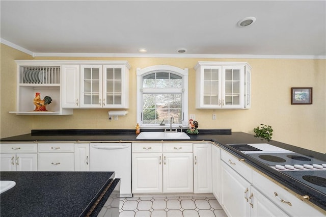 kitchen featuring dishwasher, dark countertops, ornamental molding, and a sink