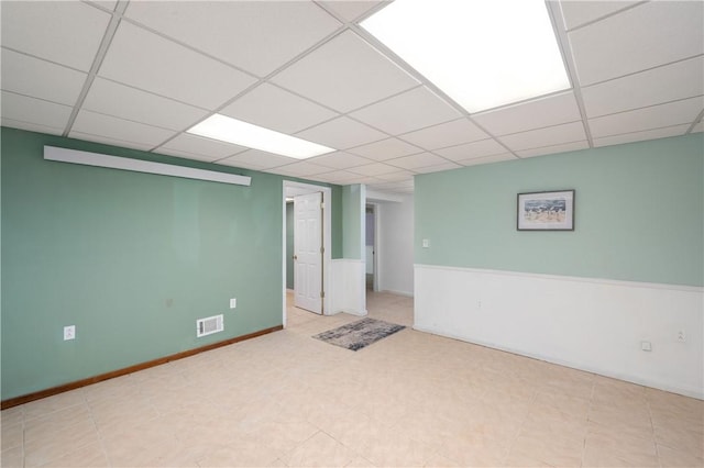 unfurnished room featuring visible vents and a drop ceiling