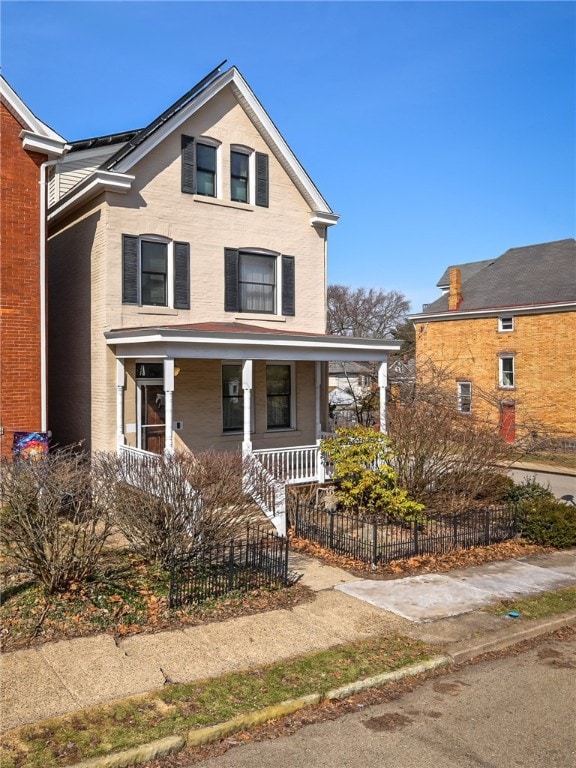 view of front of house with a fenced front yard and covered porch