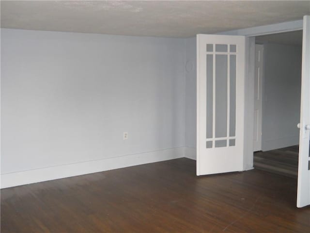 spare room with wood finished floors