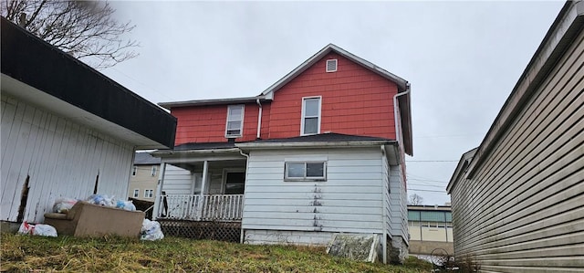 rear view of property featuring a porch