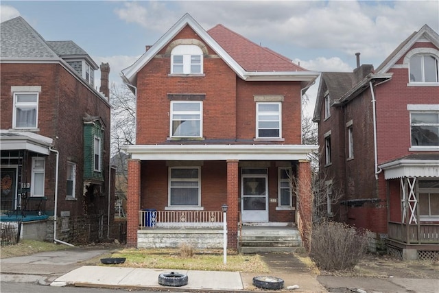 view of front of house with brick siding and covered porch