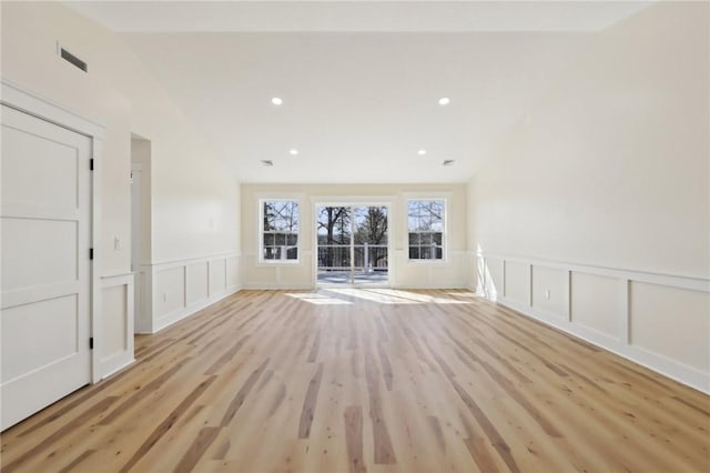 spare room with recessed lighting, wainscoting, light wood-style flooring, and a decorative wall