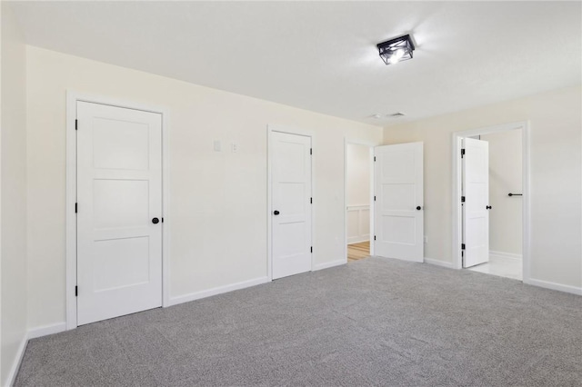 unfurnished bedroom with baseboards and carpet floors