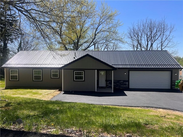 ranch-style home with a front yard, driveway, and an attached garage