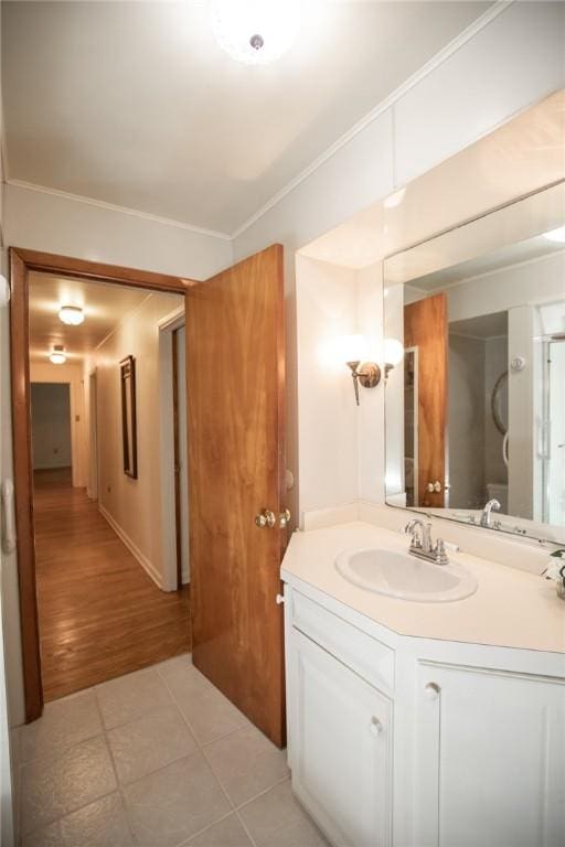 bathroom featuring ornamental molding, vanity, and tile patterned floors