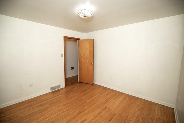 unfurnished room featuring light wood-style flooring and baseboards