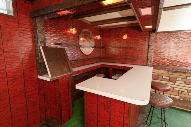 bar with beamed ceiling and carpet floors