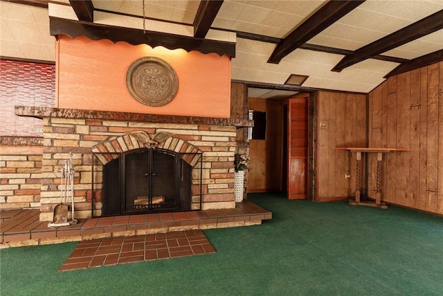 unfurnished living room with wooden walls, a fireplace with raised hearth, and carpet flooring