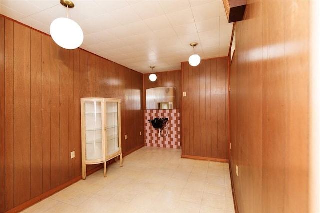spare room featuring wooden walls and tile patterned floors