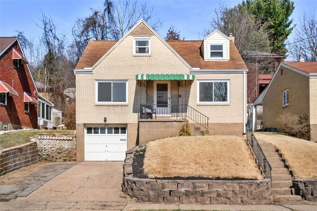 236 Center Ave, Emsworth, PA 15202 - view of front facade featuring brick siding, concrete driveway, stairs, a chimney, and an attached garage
