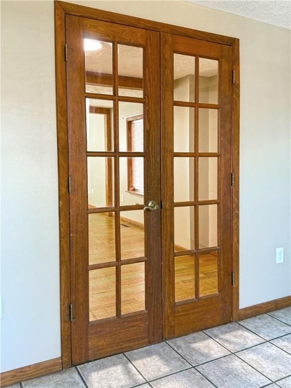 478 Spang Ave, Leechburg Boro, PA 15656 - entryway with light tile patterned floors, french doors, baseboards, and a textured ceiling
