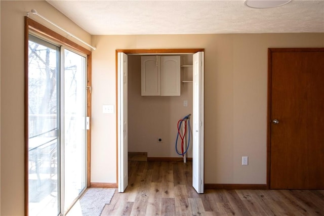 478 Spang Ave, Leechburg Boro, PA 15656 - unfurnished bedroom with baseboards, light wood-style flooring, a closet, a textured ceiling, and access to outside