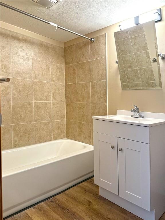 478 Spang Ave, Leechburg Boro, PA 15656 - bathroom featuring bathtub / shower combination, vanity, wood finished floors, and a textured ceiling