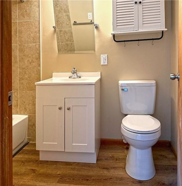478 Spang Ave, Leechburg Boro, PA 15656 - bathroom featuring baseboards, toilet, wood finished floors, and vanity
