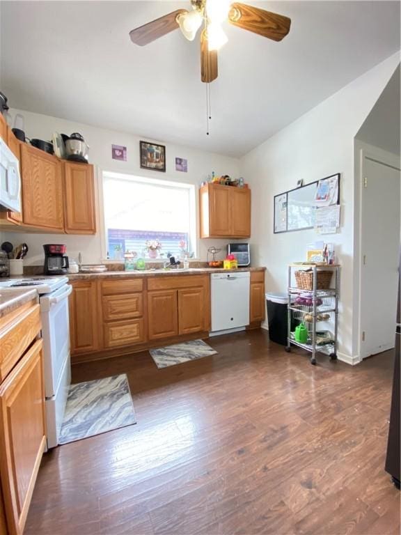kitchen with light countertops, white appliances, ceiling fan, a sink, and dark wood-style floors
