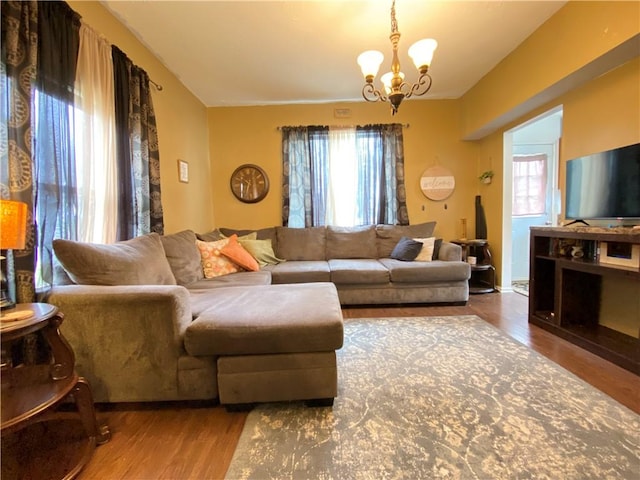 living room featuring a notable chandelier and wood finished floors