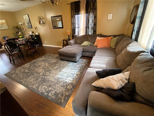 living area featuring baseboards and wood finished floors