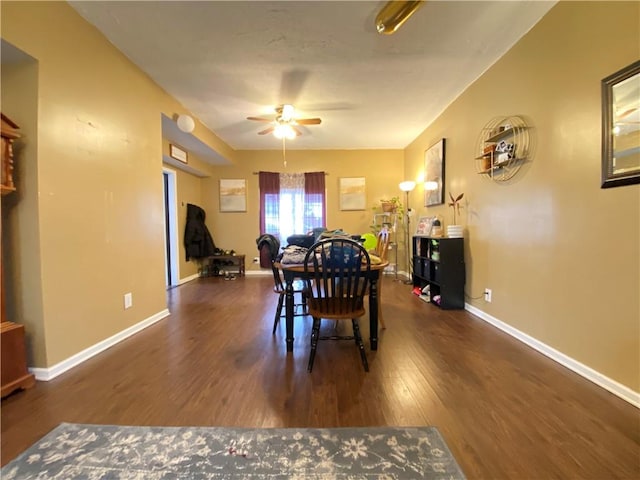 dining space with baseboards, wood finished floors, and a ceiling fan