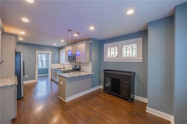 3361 Portola Ave, Observatory Hill, PA 15214 - kitchen with appliances with stainless steel finishes, a peninsula, dark wood-type flooring, light stone countertops, and recessed lighting