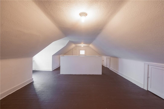 3361 Portola Ave, Observatory Hill, PA 15214 - additional living space featuring a textured ceiling, dark wood-style flooring, and vaulted ceiling