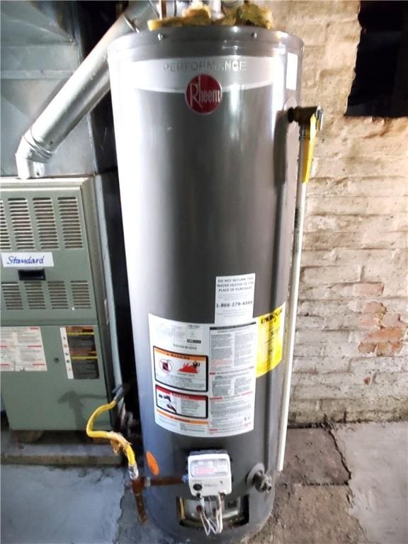 utility room featuring gas water heater