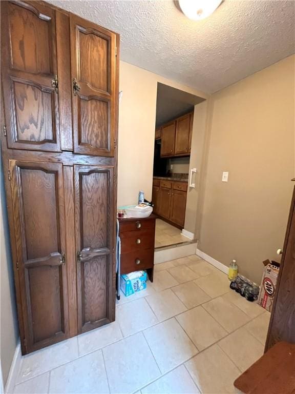310 Church St, Harrisville Boro, PA 16038 - bathroom with a textured ceiling, baseboards, and tile patterned flooring