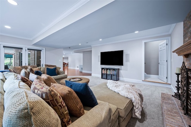 carpeted living area featuring recessed lighting, baseboards, a brick fireplace, and ornamental molding