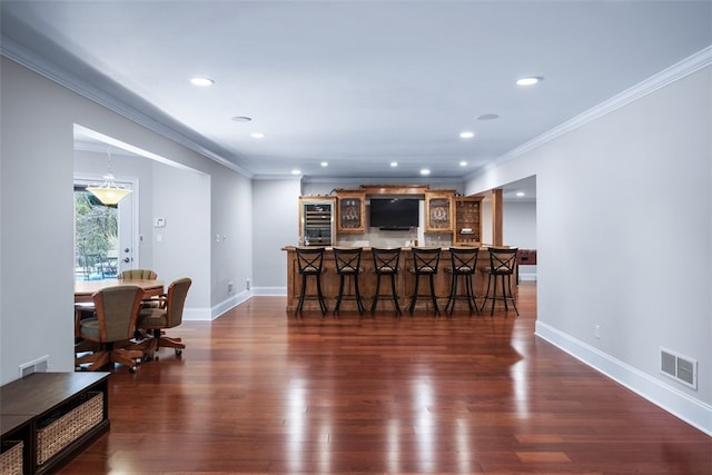 bar with dark wood-type flooring, bar area, baseboards, and visible vents