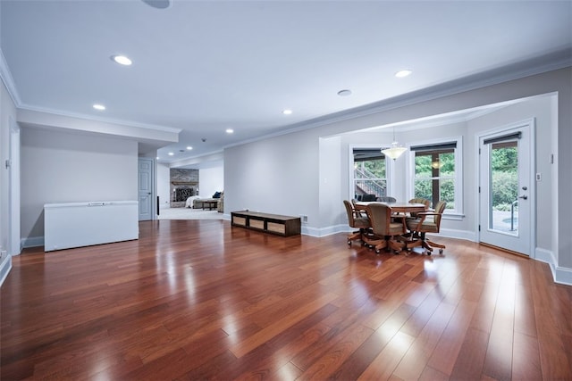 interior space featuring recessed lighting, wood finished floors, and ornamental molding
