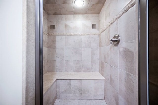 bathroom with a tile shower