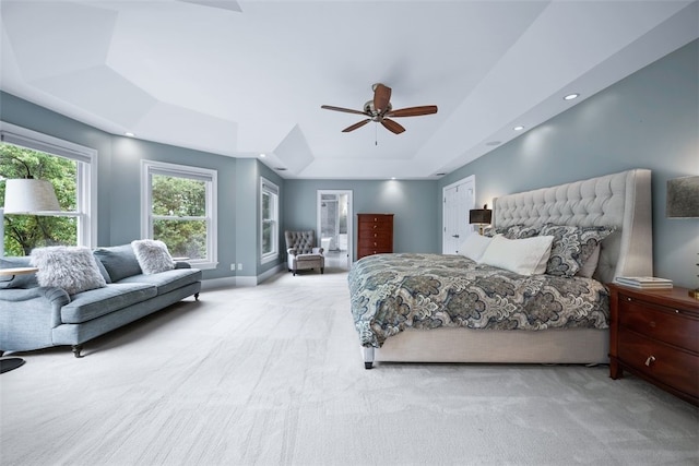 carpeted bedroom featuring recessed lighting, baseboards, a raised ceiling, and ceiling fan