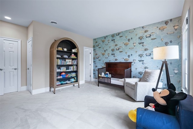 sitting room with visible vents, wallpapered walls, baseboards, built in features, and carpet flooring