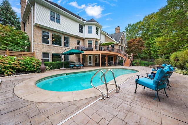 view of swimming pool with stairway, a fenced in pool, a patio, and fence