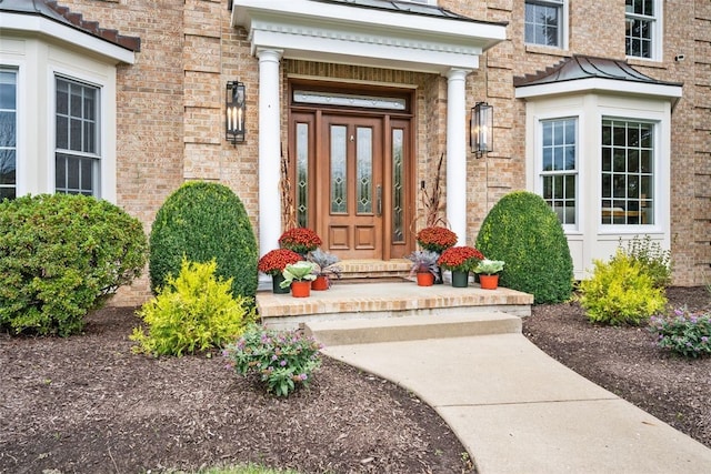entrance to property featuring brick siding